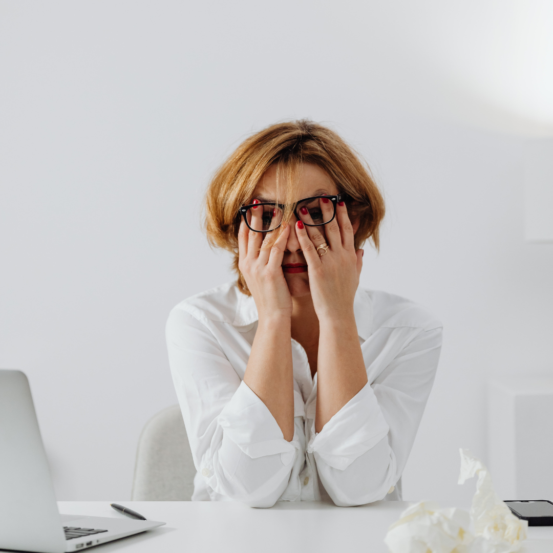 A woman professional being frustrated at work due to career misalignment.